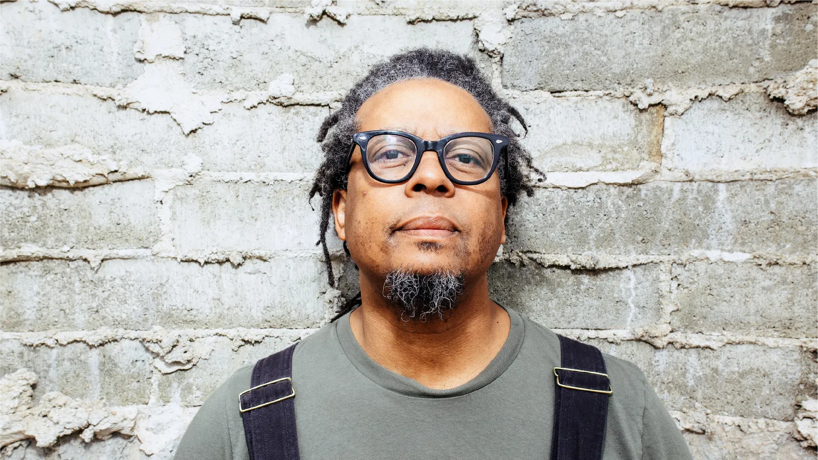 Jeff Parker smiling in front of a brick wall